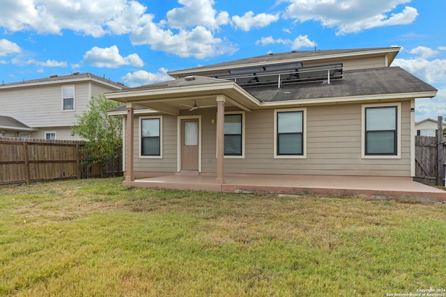 rear view of house featuring a yard and a patio