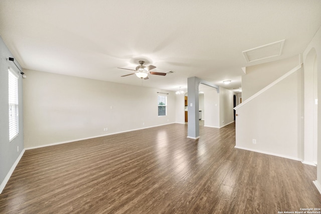 unfurnished living room featuring dark hardwood / wood-style floors and ceiling fan