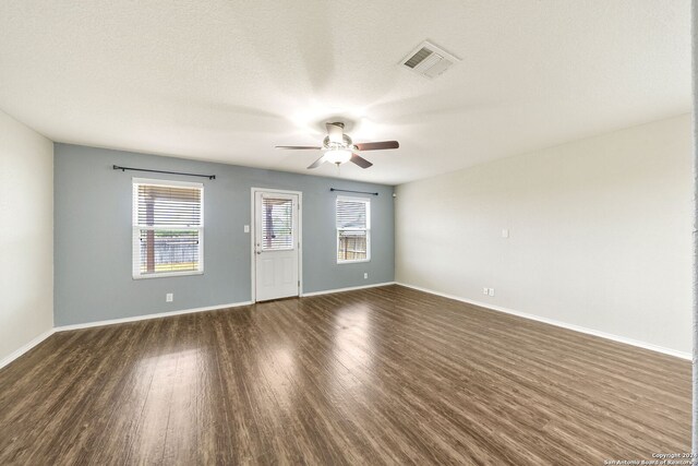 unfurnished room featuring a textured ceiling, dark wood-type flooring, and ceiling fan