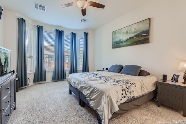 bedroom with ceiling fan and light carpet