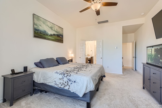 carpeted bedroom with ceiling fan and ensuite bath