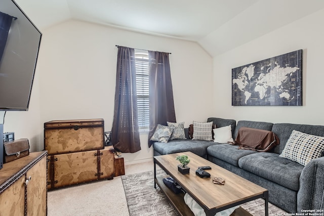 living room featuring lofted ceiling and light carpet