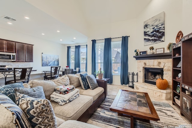 living room with a stone fireplace