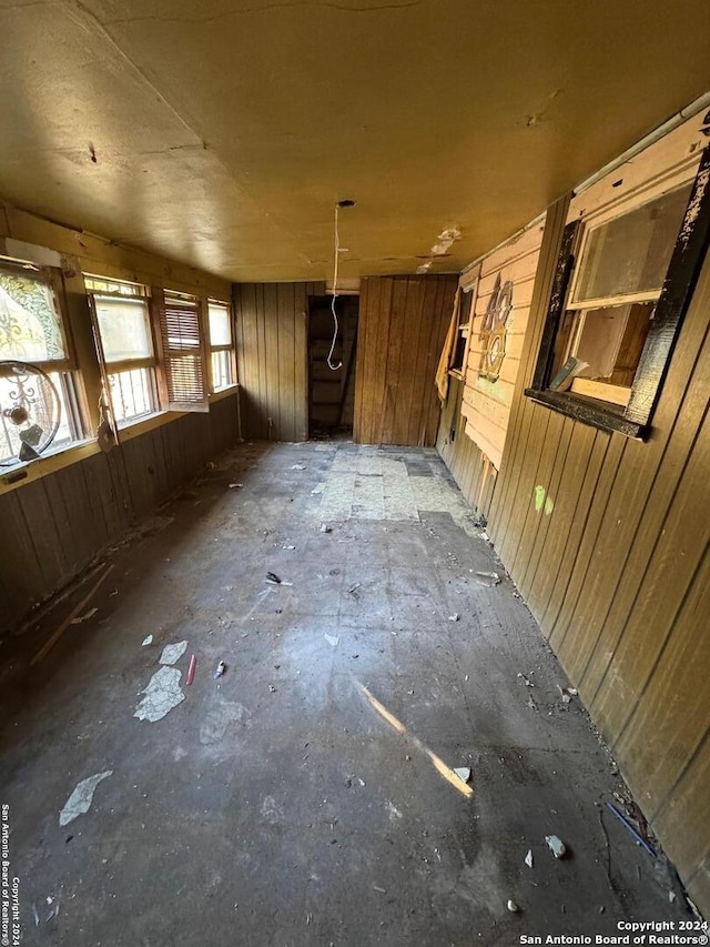 miscellaneous room featuring wooden walls