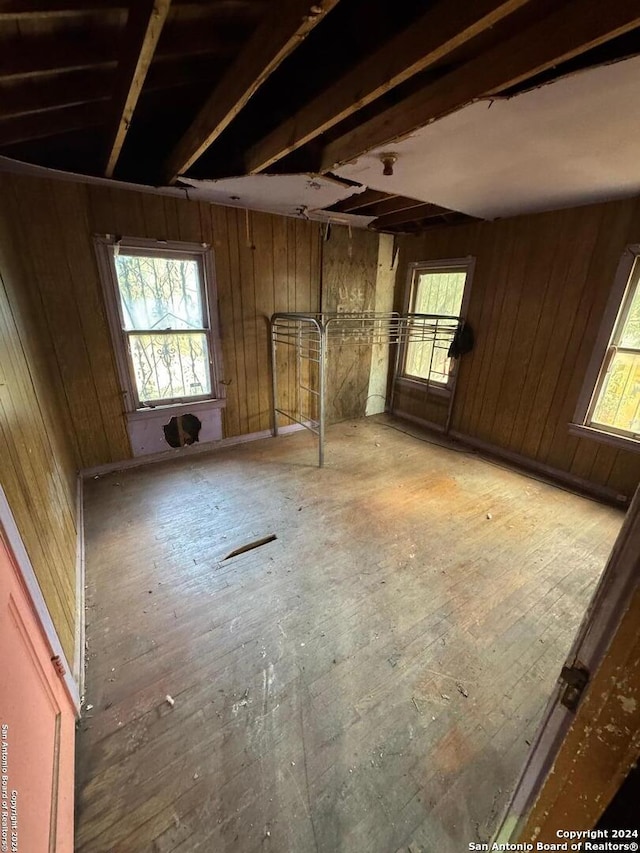 empty room featuring hardwood / wood-style floors and wood walls