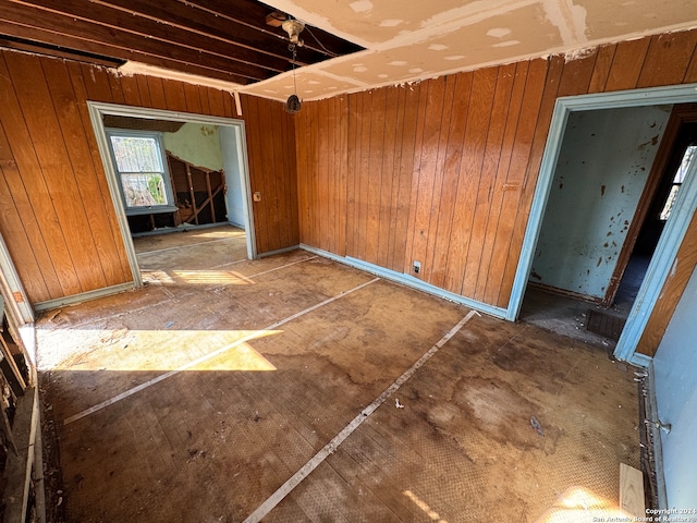 unfurnished room with wooden walls