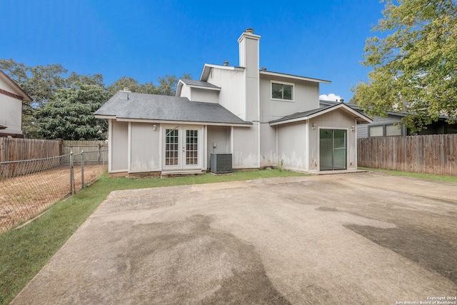 rear view of house with a patio area and cooling unit