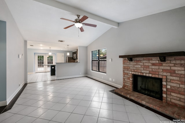 unfurnished living room featuring french doors, a healthy amount of sunlight, lofted ceiling with beams, and a brick fireplace