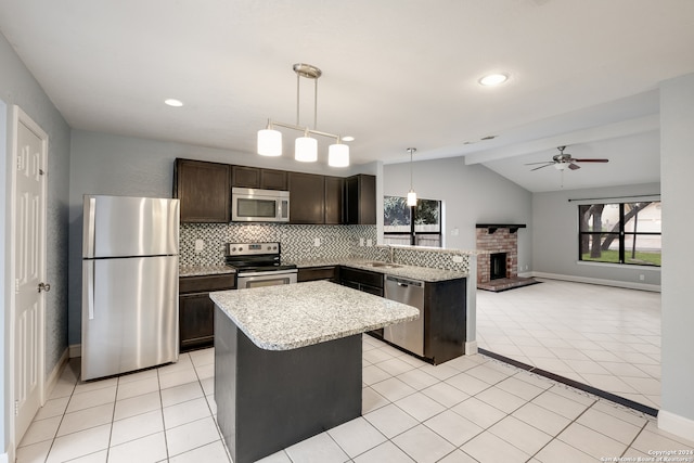 kitchen with ceiling fan, appliances with stainless steel finishes, a center island, and pendant lighting