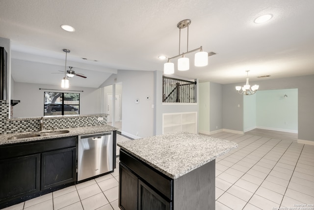 kitchen with decorative backsplash, a kitchen island, vaulted ceiling, dishwasher, and sink