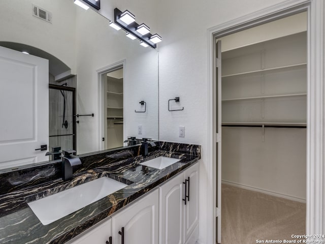 bathroom featuring vanity and an enclosed shower