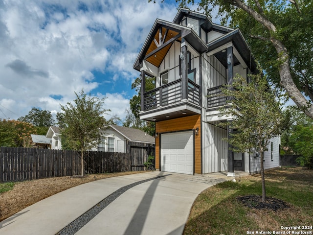 view of front of home with a garage and a balcony