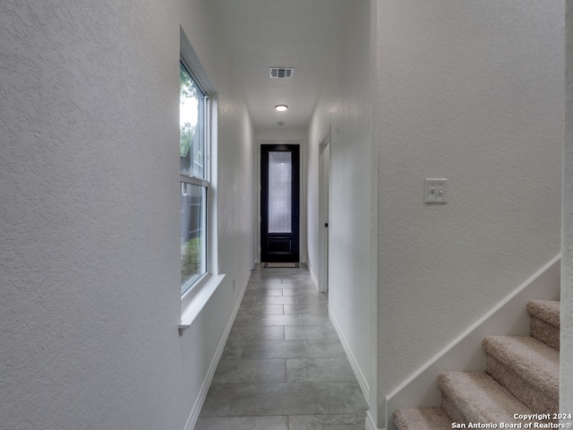 corridor featuring light tile patterned floors