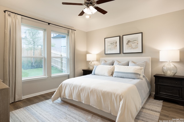 bedroom with dark wood-type flooring and ceiling fan