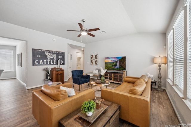 living room featuring a wealth of natural light, hardwood / wood-style floors, vaulted ceiling, and ceiling fan