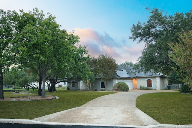 view of front of property featuring a yard and a garage