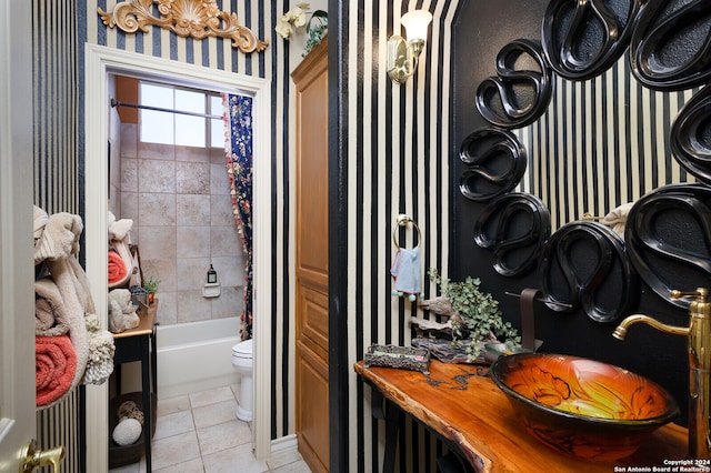 full bathroom with toilet, shower / tub combo with curtain, vanity, and tile patterned flooring