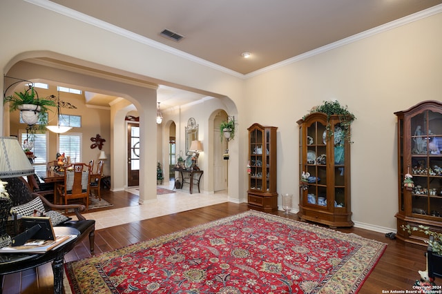 entryway featuring ornamental molding and hardwood / wood-style floors