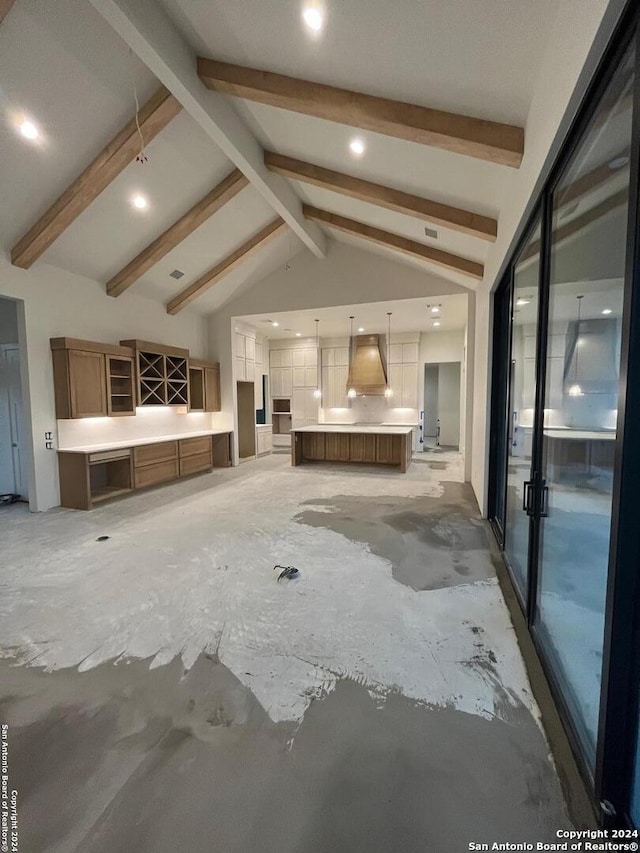 unfurnished living room with lofted ceiling with beams