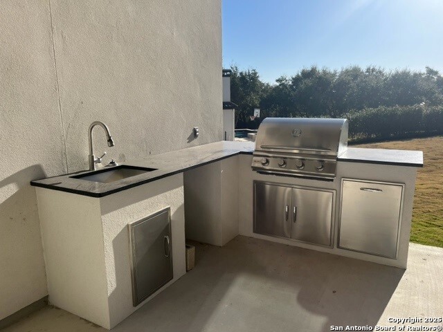 view of patio featuring sink, grilling area, and an outdoor kitchen