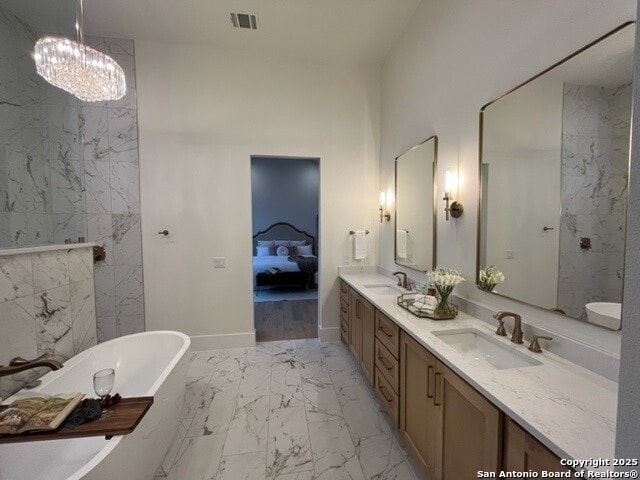 bathroom with vanity and a tub