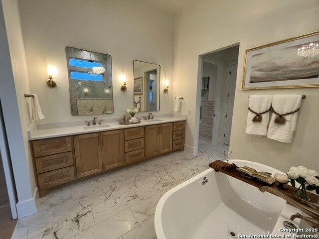 bathroom with vanity and a washtub