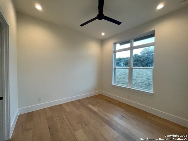 empty room with light hardwood / wood-style floors and ceiling fan