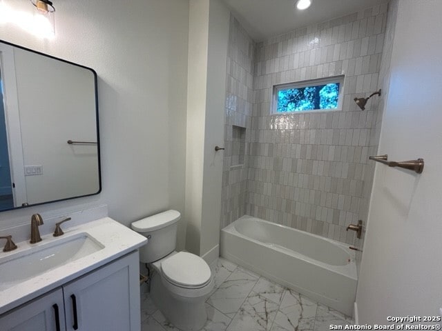 full bathroom with vanity, toilet, and tiled shower / bath combo