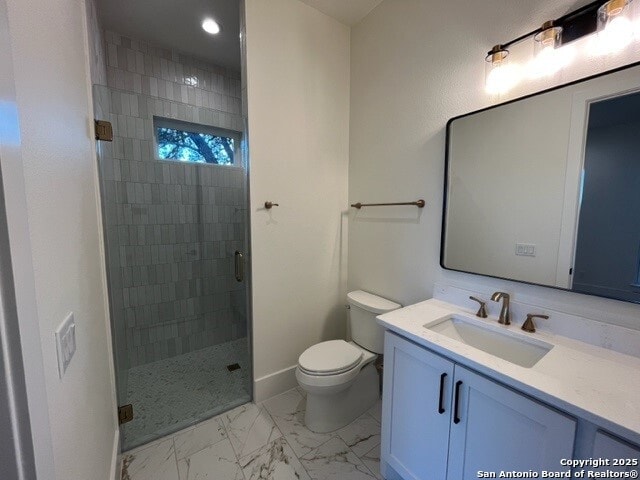 bathroom with vanity, toilet, and a shower with shower door