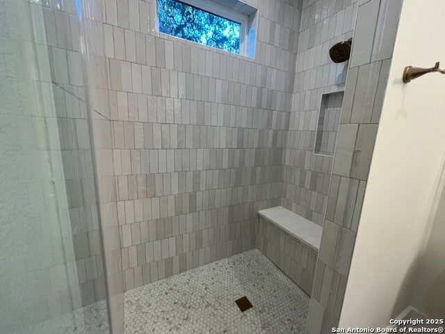 bathroom with a tile shower