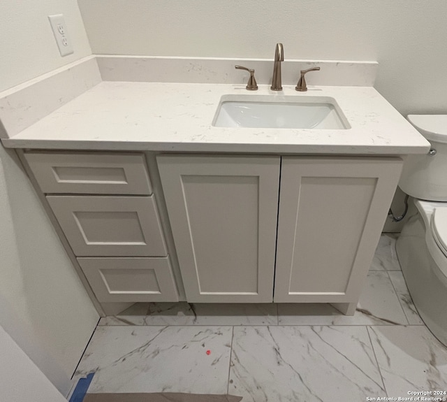 bathroom featuring vanity and toilet