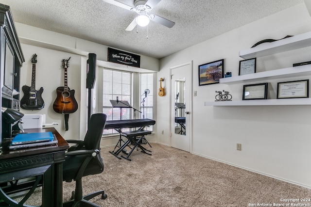 home office with a textured ceiling, carpet flooring, and ceiling fan