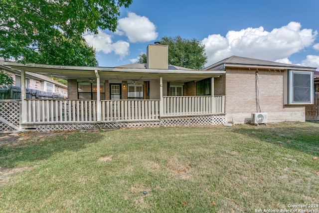 back of house with a yard and ac unit