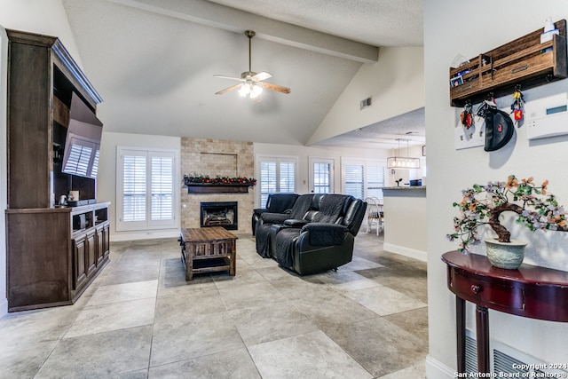 living room featuring a wealth of natural light, a textured ceiling, high vaulted ceiling, and ceiling fan with notable chandelier