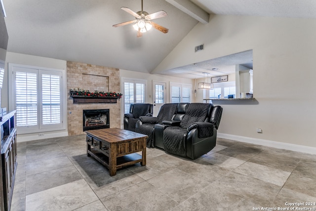 living room with a fireplace, beamed ceiling, a textured ceiling, high vaulted ceiling, and ceiling fan