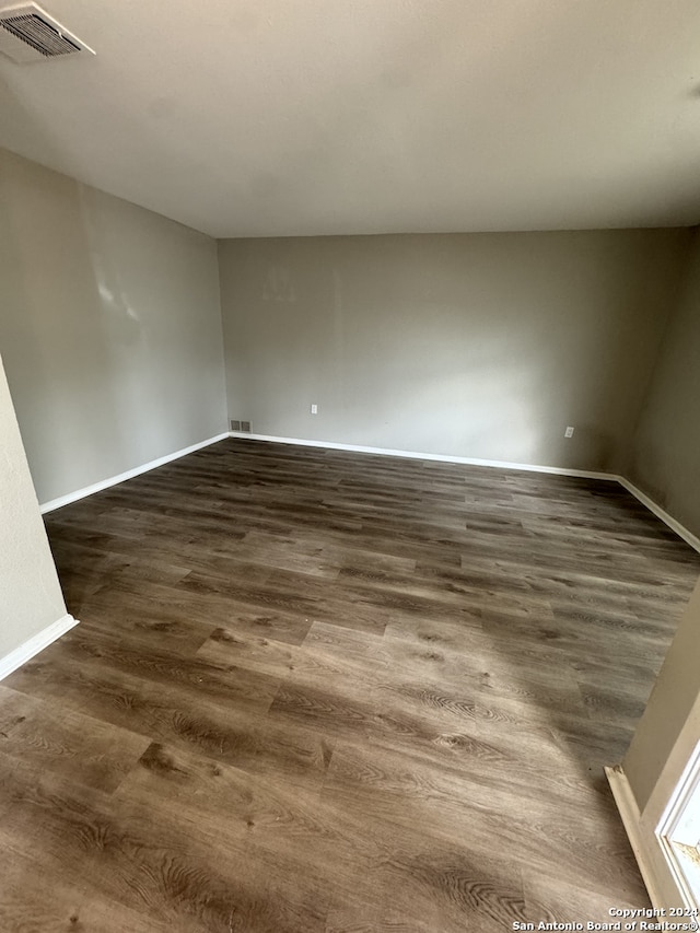 spare room featuring dark wood-type flooring