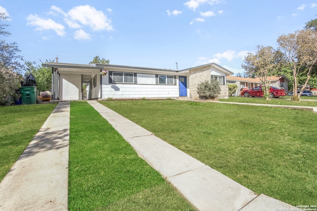 ranch-style house with a front lawn and a carport