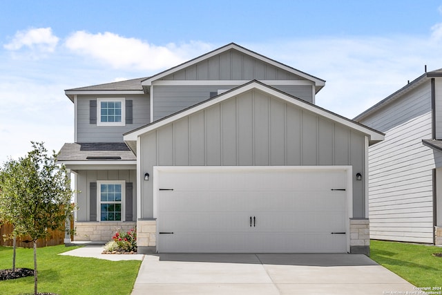 craftsman inspired home featuring a front yard and a garage