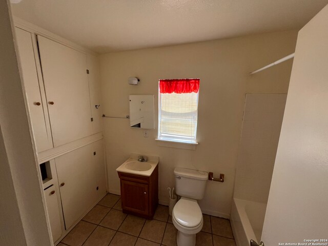 full bathroom with vanity, shower / tub combination, toilet, and tile patterned floors