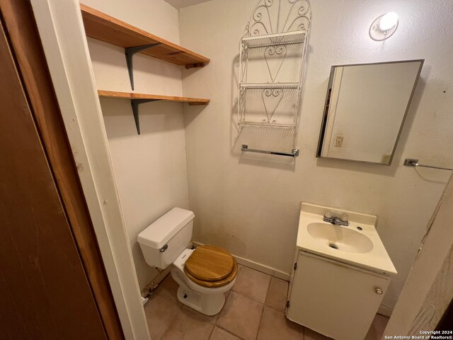 bathroom featuring vanity, toilet, and tile patterned floors