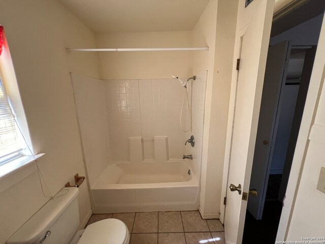 bathroom featuring tile patterned flooring, toilet, and shower / bath combination