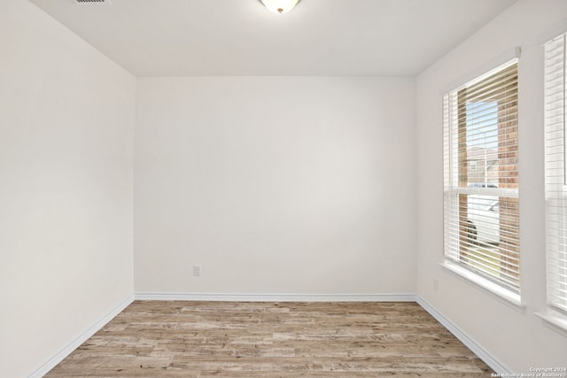 empty room with light hardwood / wood-style flooring