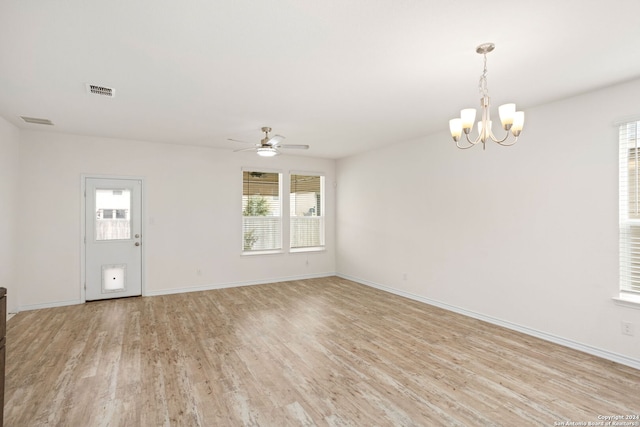 spare room with light hardwood / wood-style flooring and ceiling fan with notable chandelier