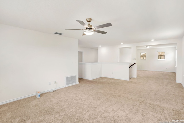 carpeted spare room featuring ceiling fan