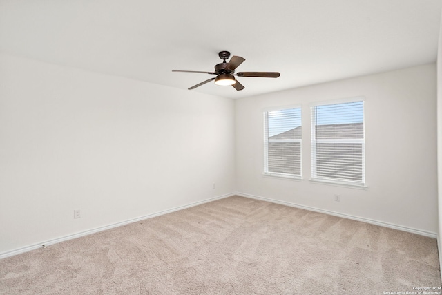 unfurnished room with light colored carpet and ceiling fan