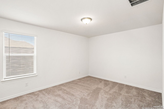 unfurnished room with light colored carpet