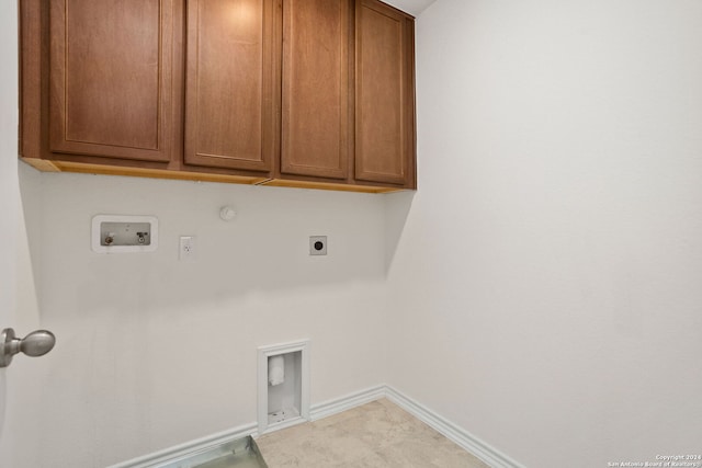 laundry room featuring hookup for a gas dryer, hookup for an electric dryer, washer hookup, and cabinets