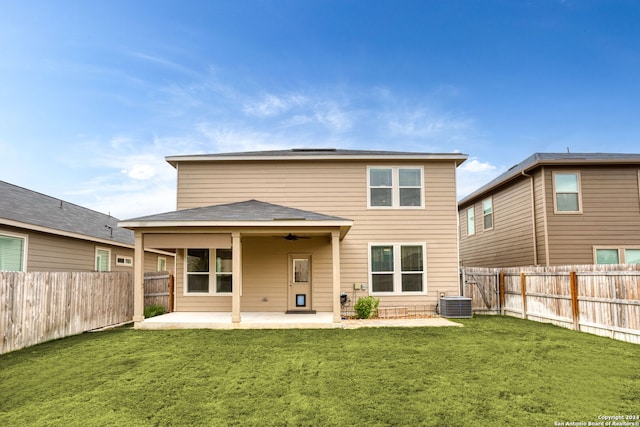 rear view of property with a patio area, a lawn, and ceiling fan