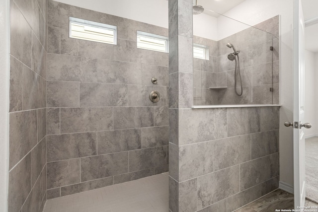 bathroom featuring a tile shower