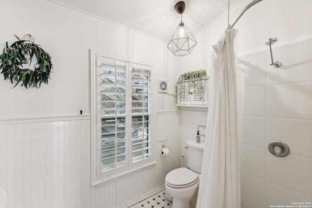 bathroom featuring a shower with shower curtain, toilet, and tile patterned flooring